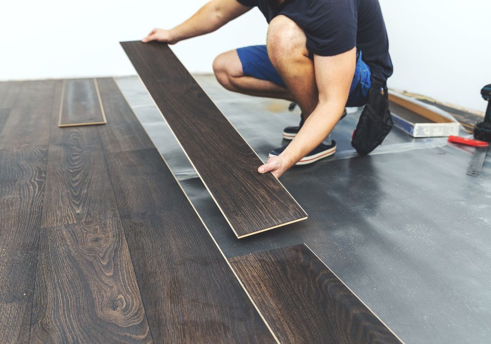 An image of someone laying floorboards