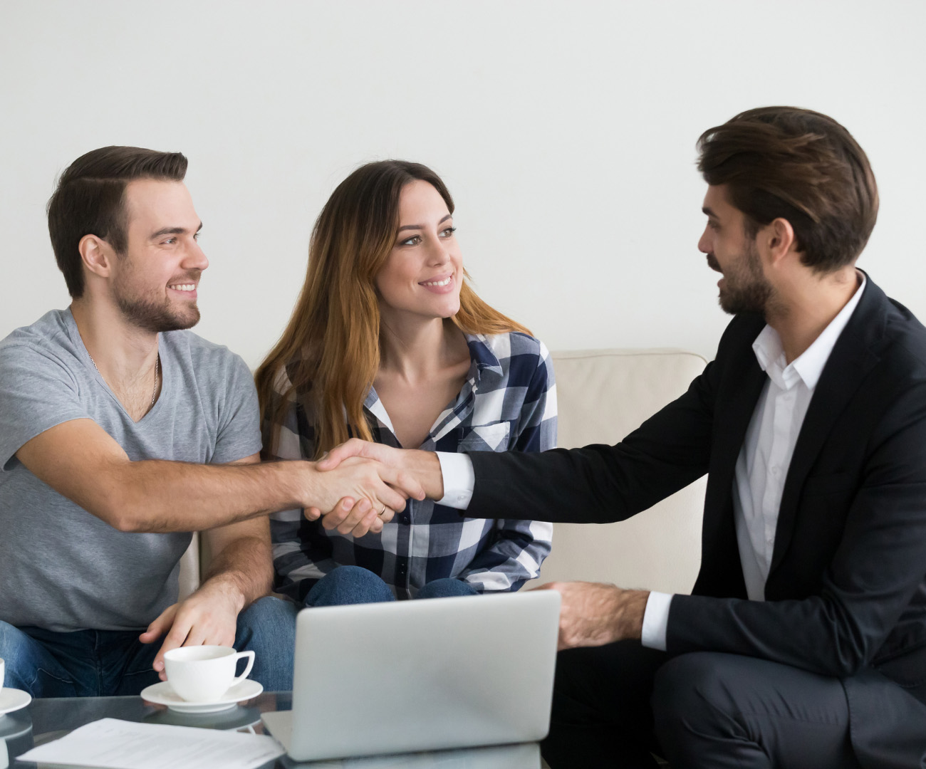 An image of a couple shaking hands with a landlord